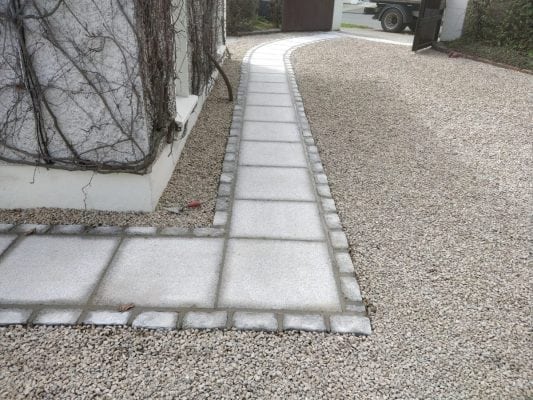 Gravel Driveway accompanied by Granite Path with Trim